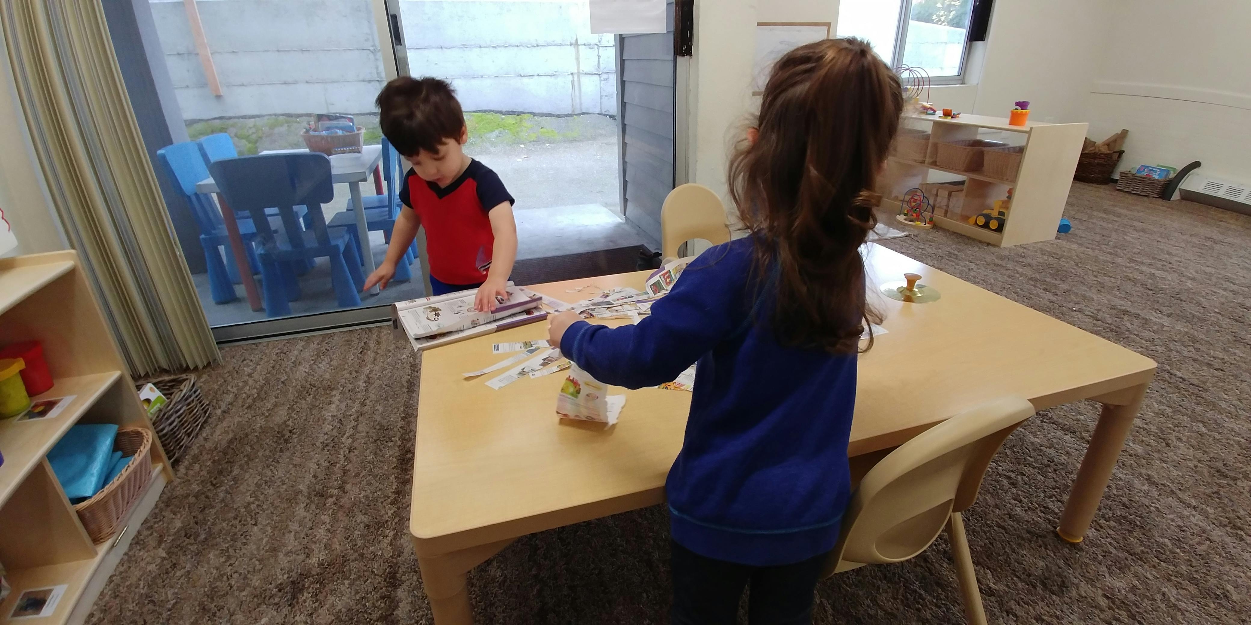 Two children at a table in a classroom