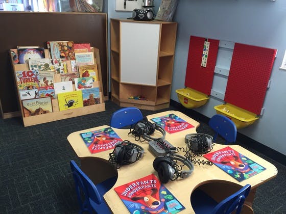 Children's listening station with headphones and books on a table