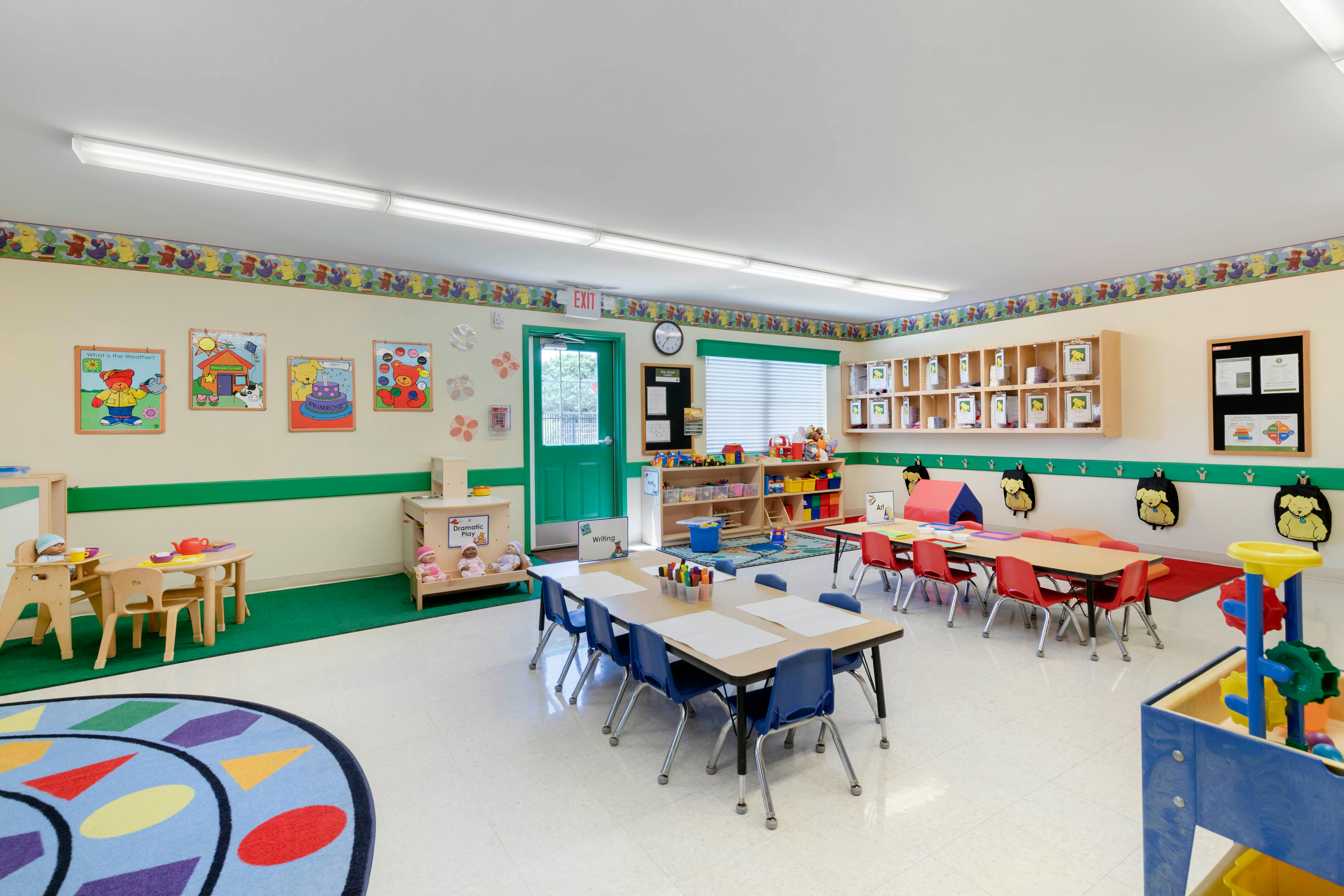 An empty early childhood classroom with colorful furniture and decorations