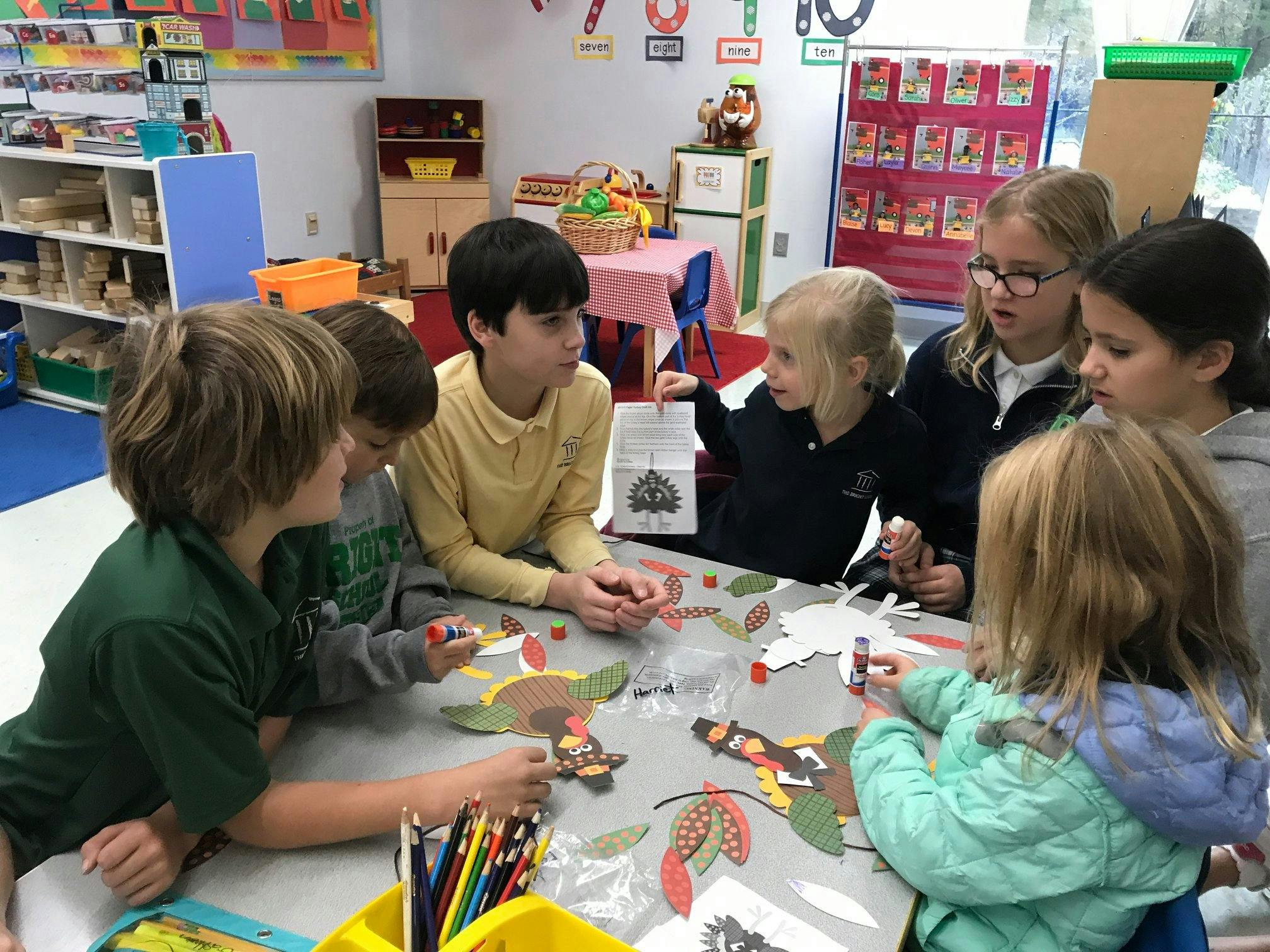 Group of children gathered around a table doing crafts
