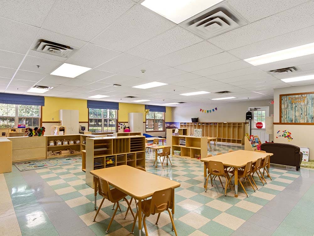 Empty classroom with small tables and chairs
