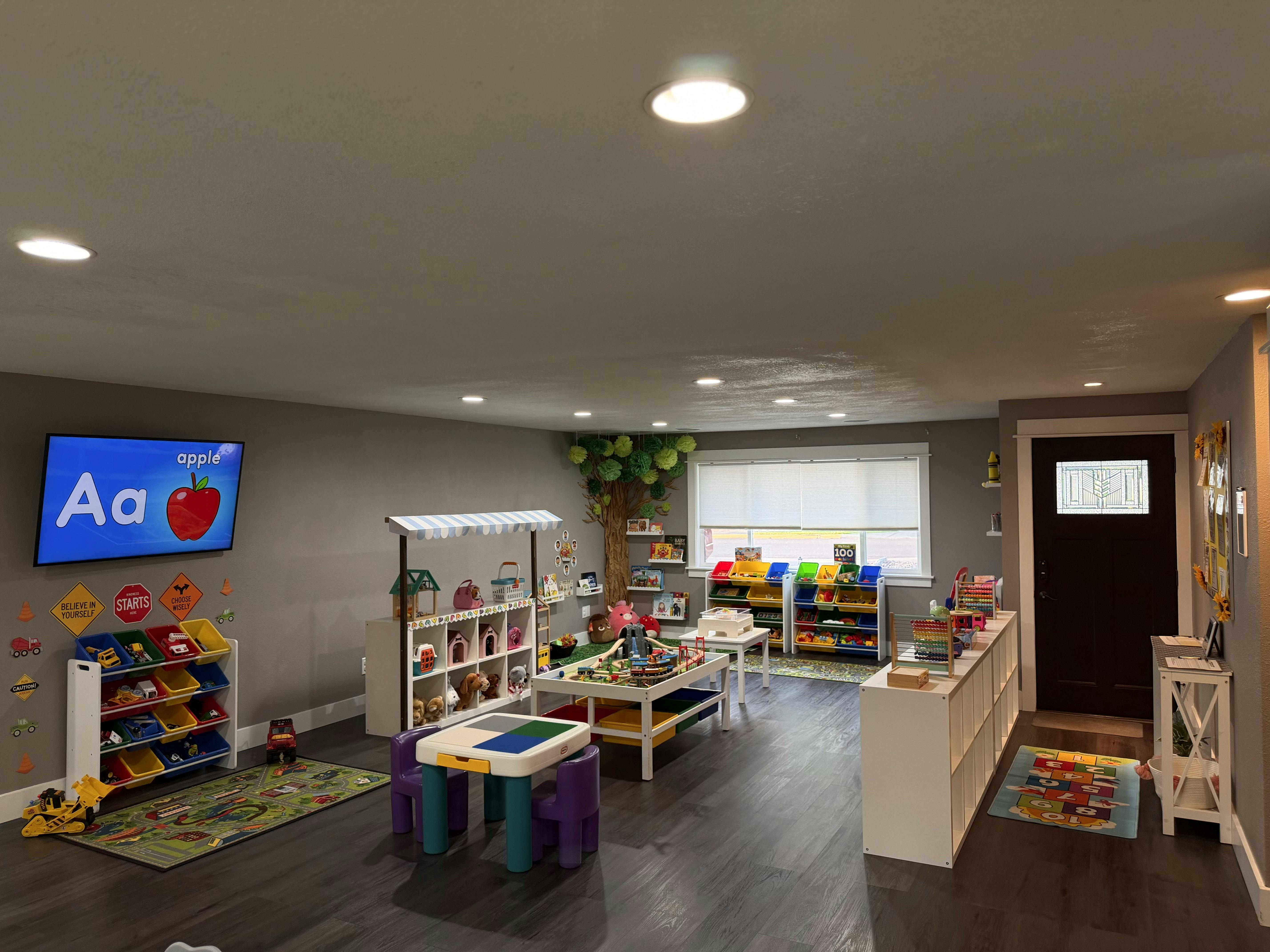 Playroom interior with organized shelves, educational rugs, and toys