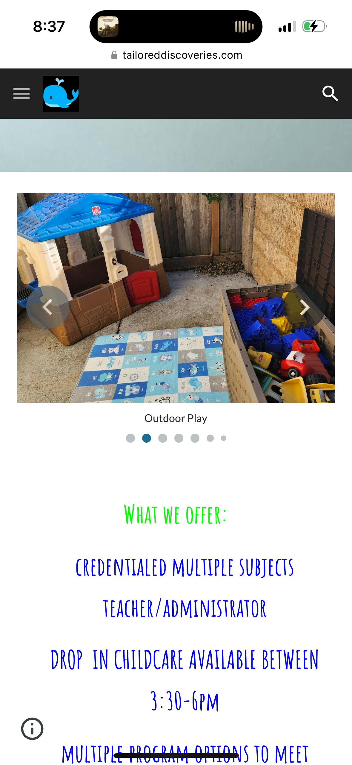 Outdoor play area with a playhouse, mat, and toy bin