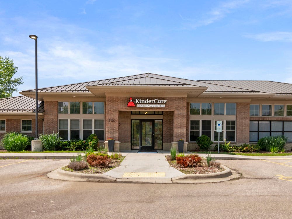 KinderCare Learning Center building exterior from the front, with a parking lot in the foreground