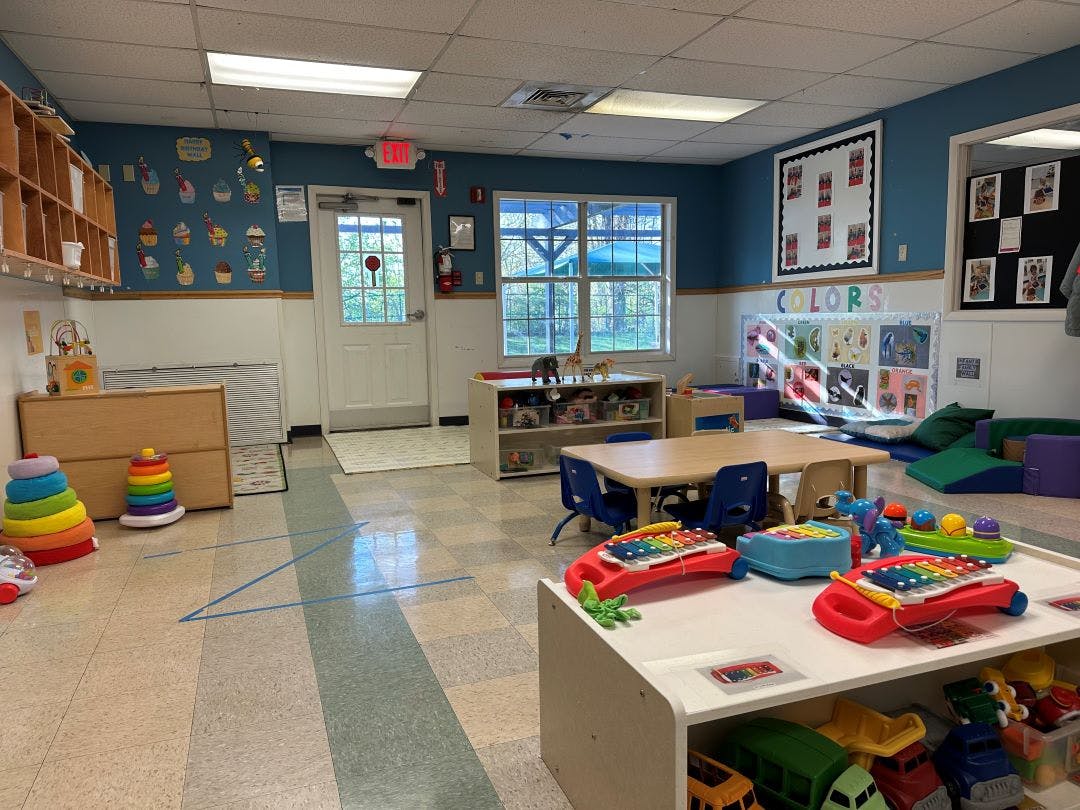 Colorful classroom with various toys, tables, and chairs for children
