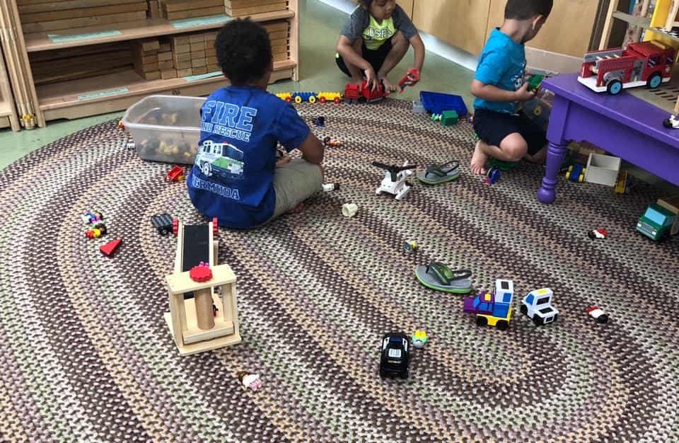 Children playing with toys on a rug
