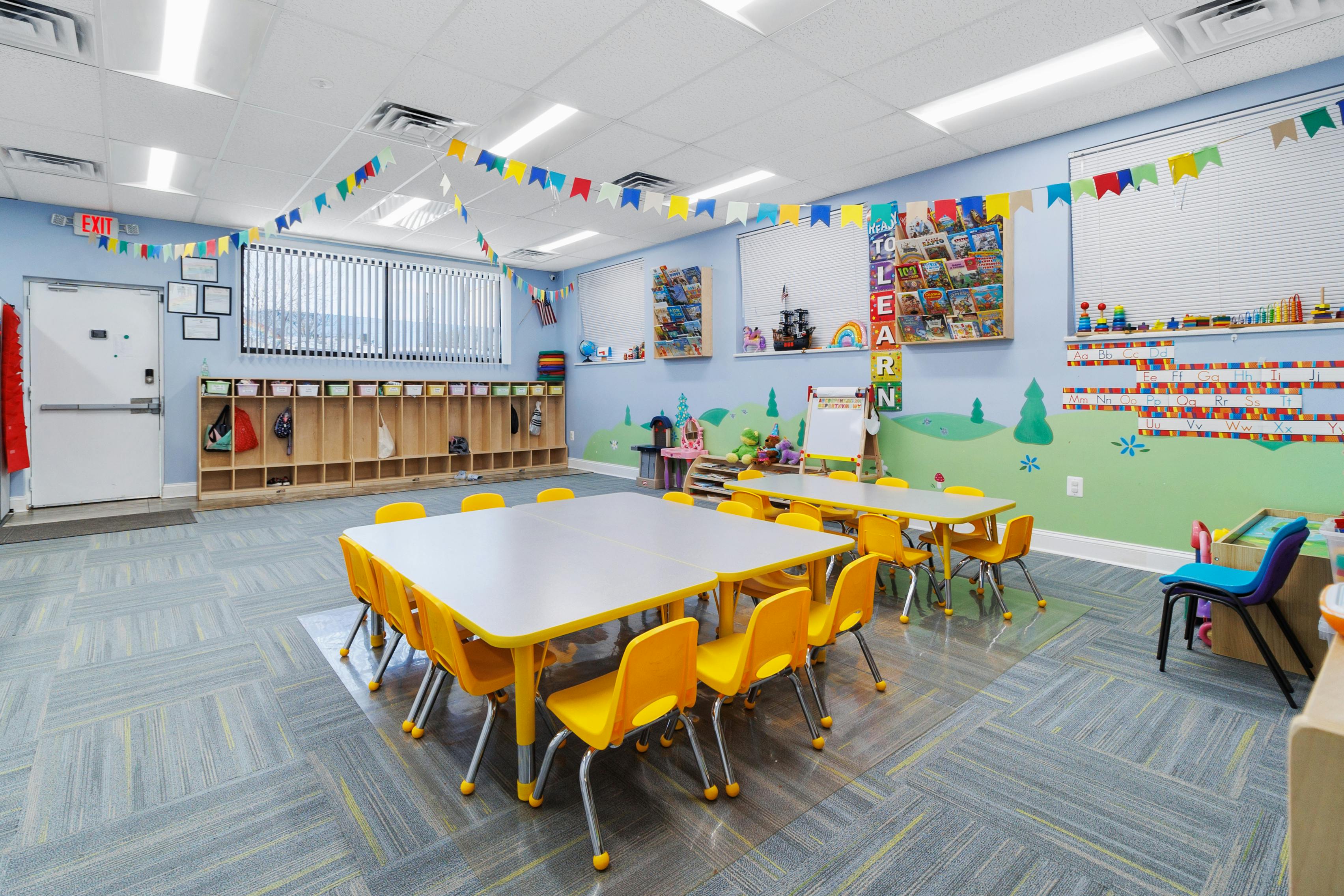 Empty classroom with small tables and chairs