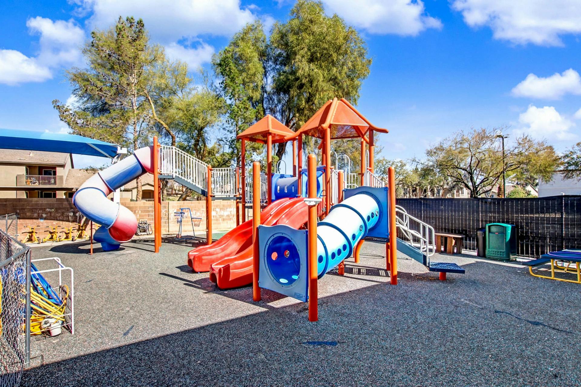 Colorful playground with multiple slides and climbing structures