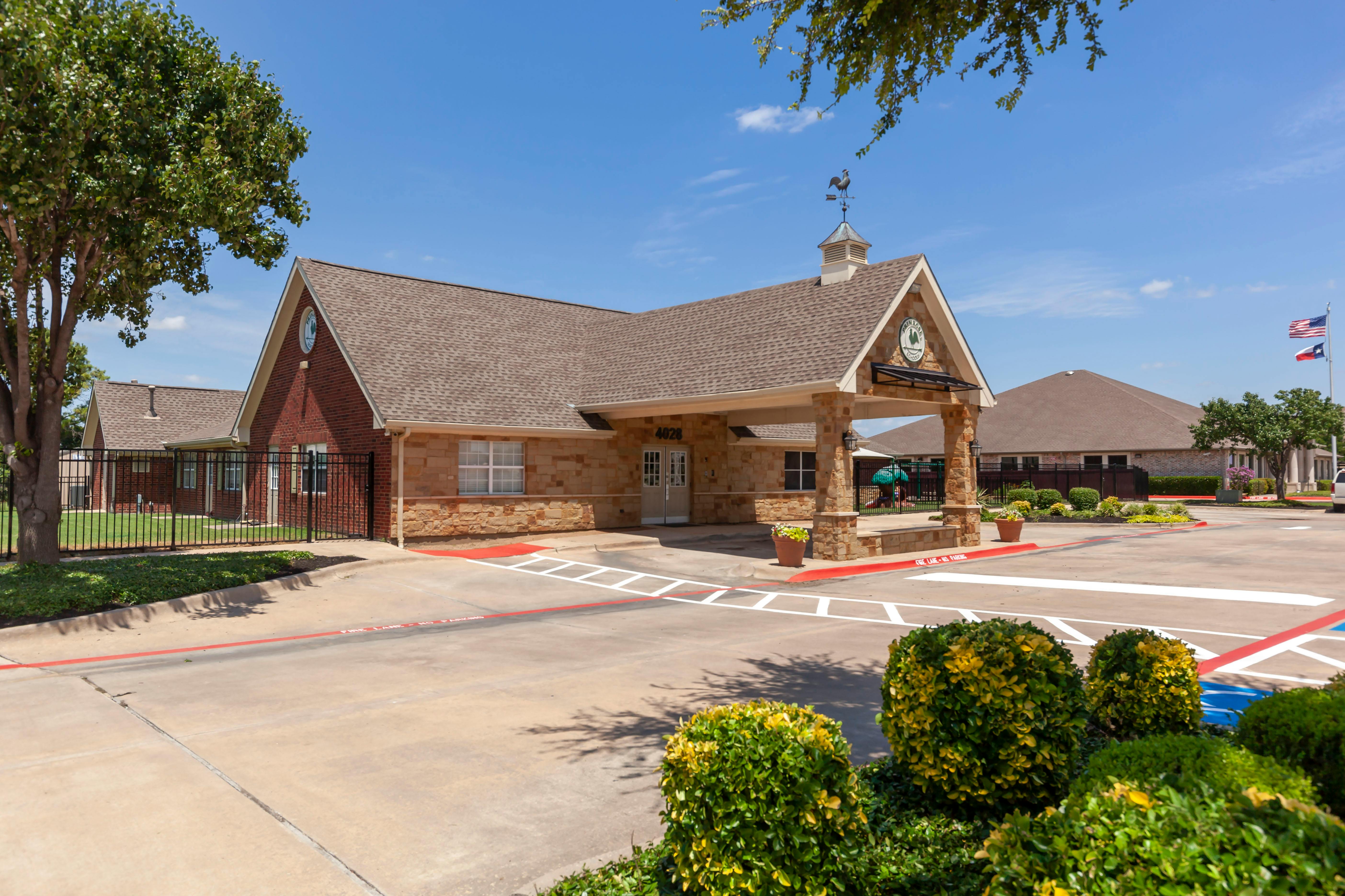 Front exterior of a single-story brick and stone building with a covered entrance