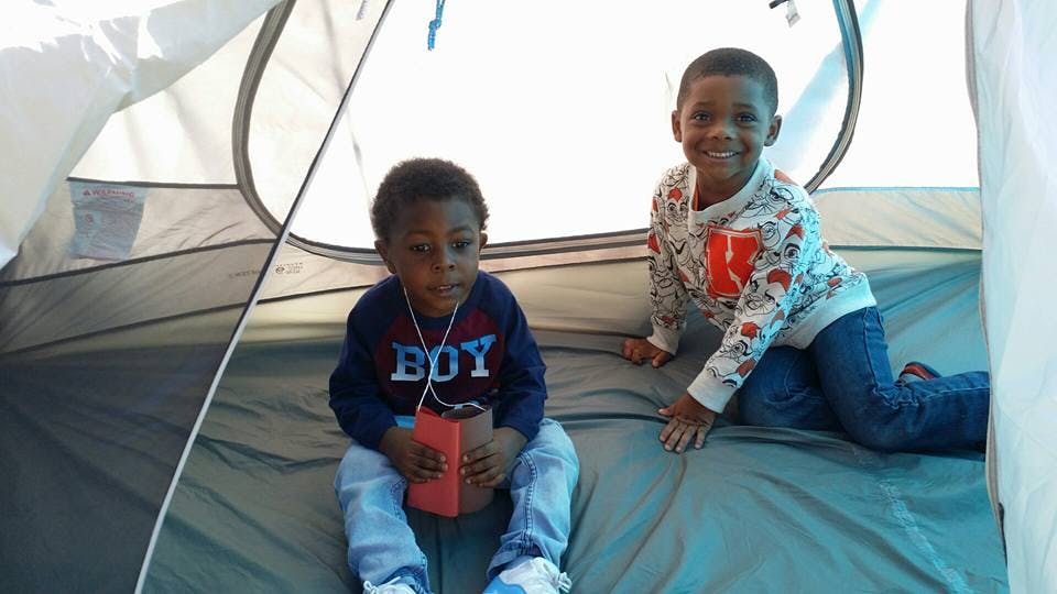 Two children inside a tent
