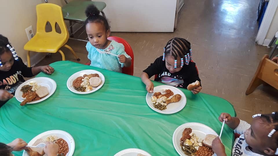 Children eating meals at a table
