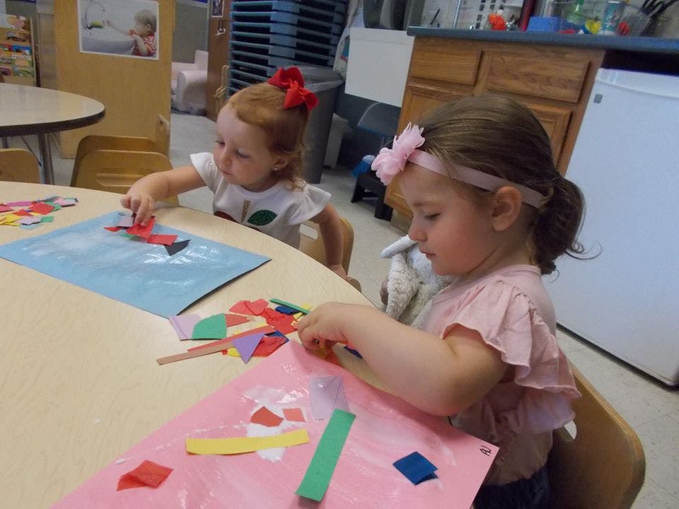 Two children doing crafts at a table