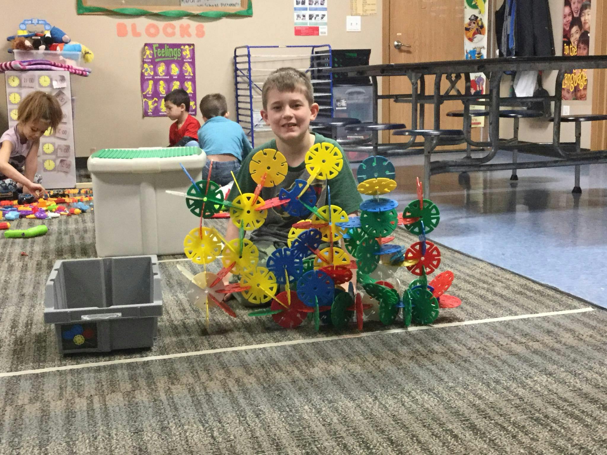 Child playing with colorful building toys in a classroom
