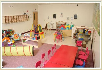 Playroom with various toys, tables, and chairs