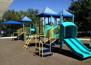 Playground with blue and yellow structures and slides