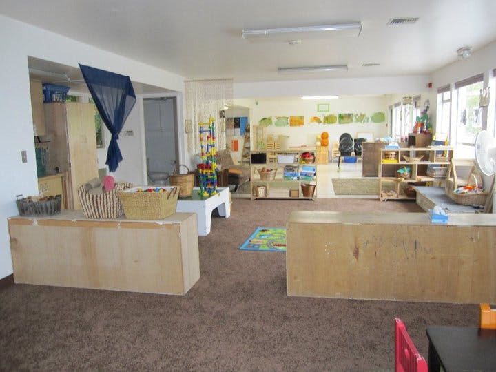 Empty classroom with various learning stations and play areas