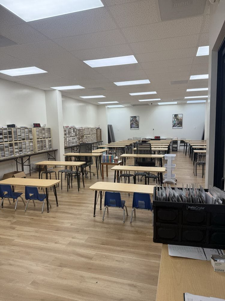 empty classroom with rows of tables and chairs