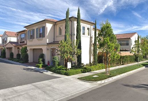 Row of attached houses with garages and landscaping