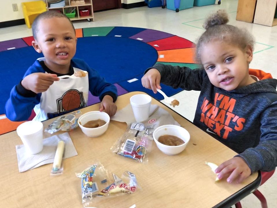 Two children eating at a table