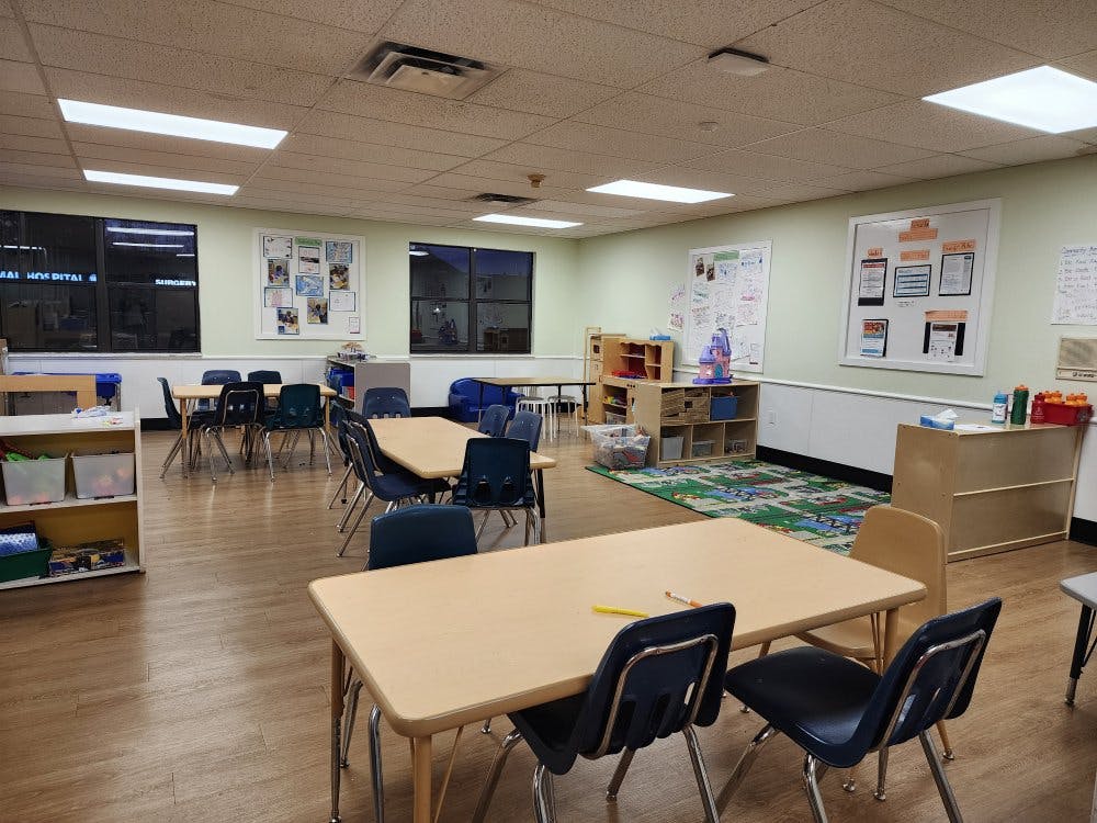 Empty classroom with small tables and chairs