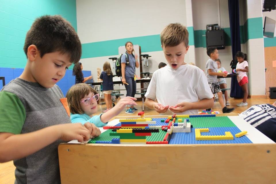 Children playing with building blocks at a table