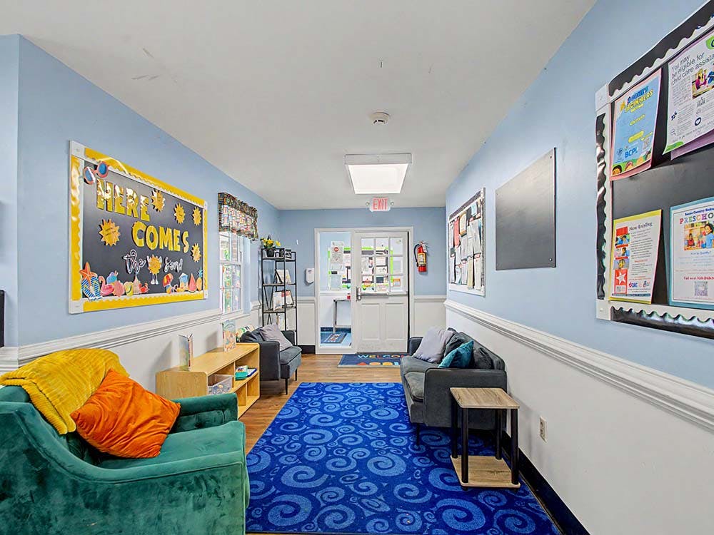 Lounge area in an educational setting with couches and bulletin boards