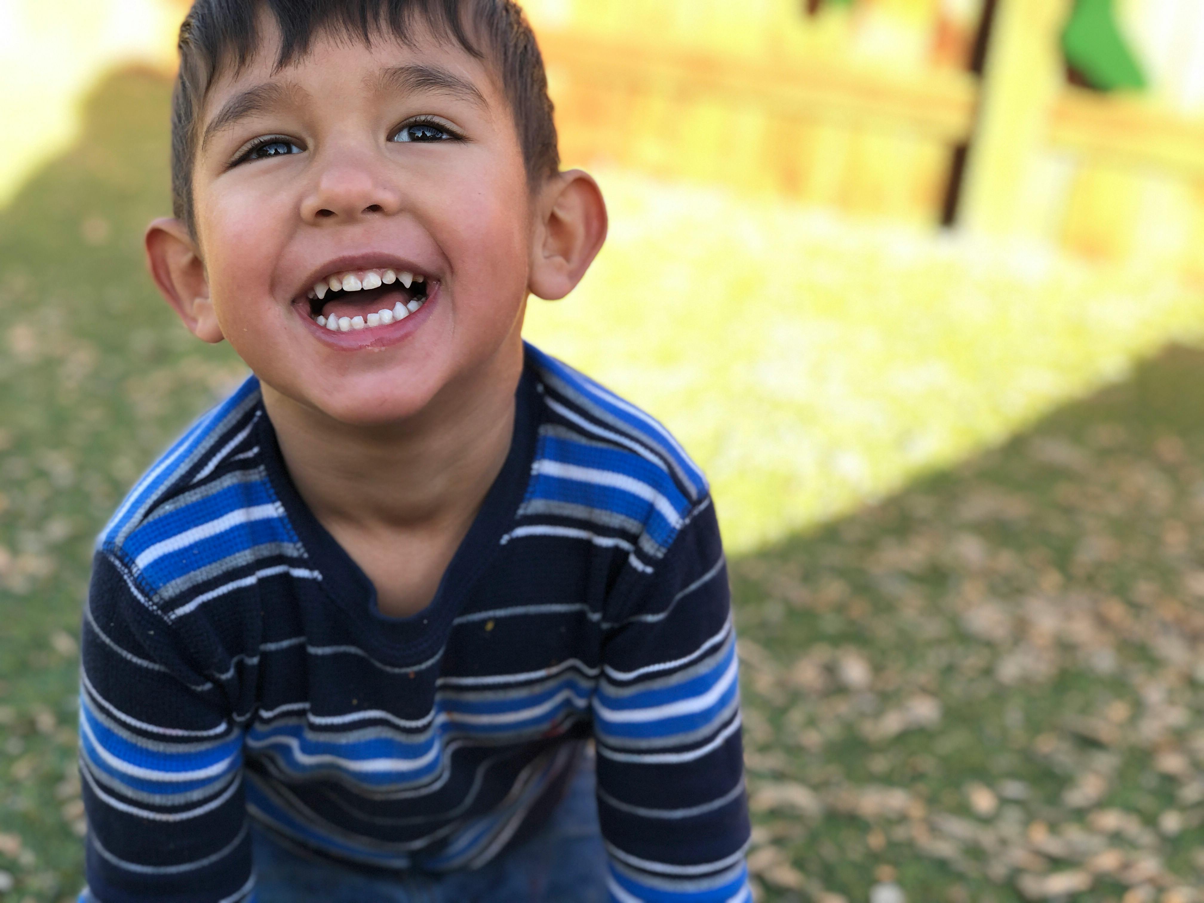 Child in a striped shirt smiling