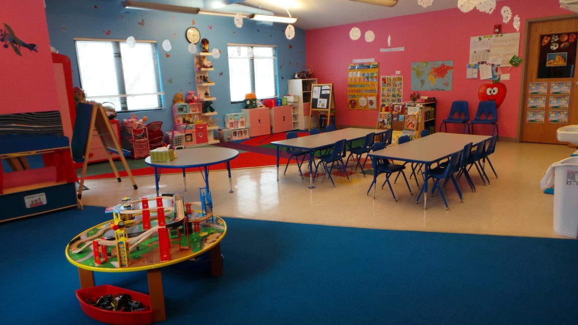 Playroom with tables, chairs, and toys