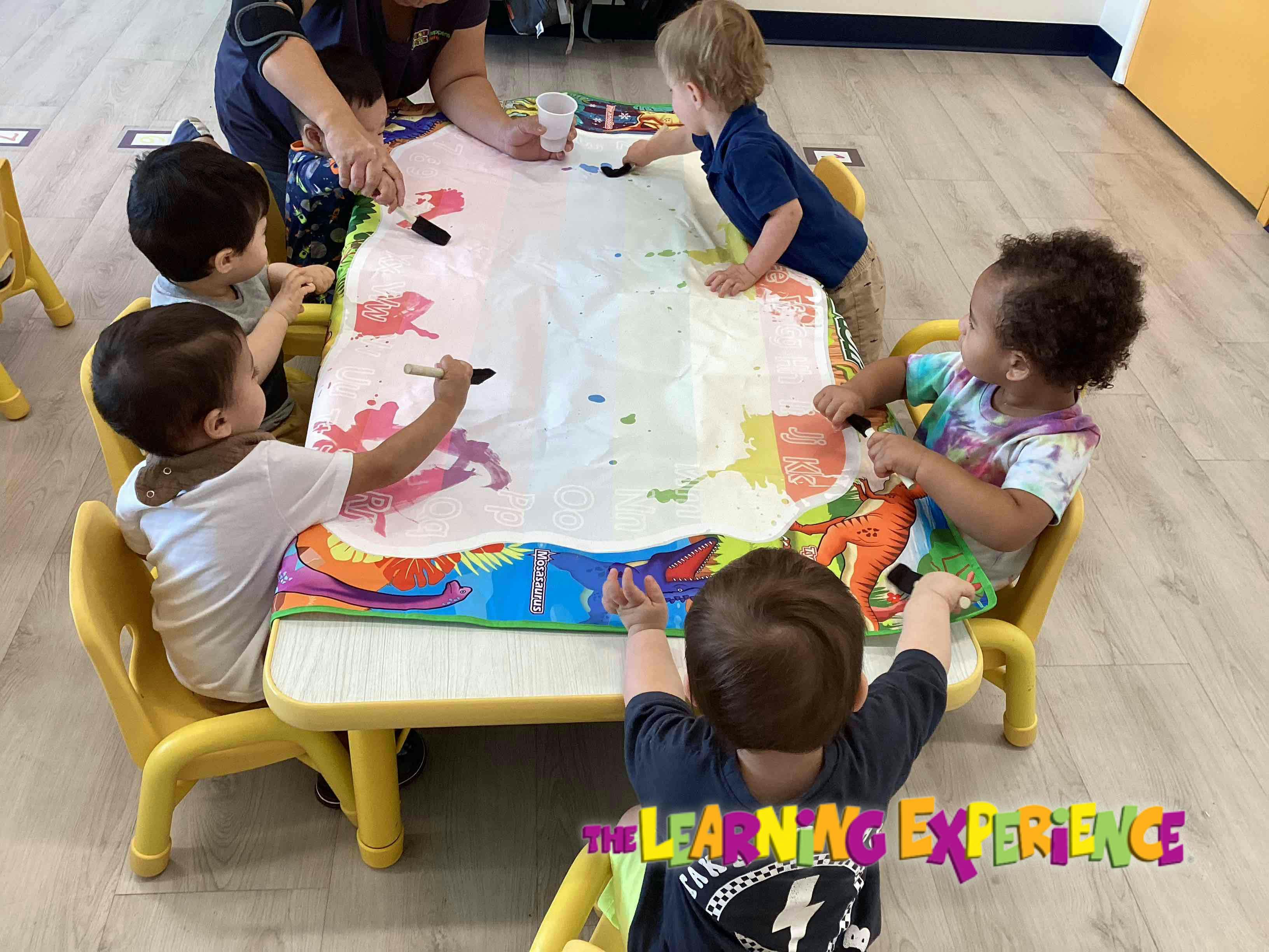 Adult and children painting at a table
