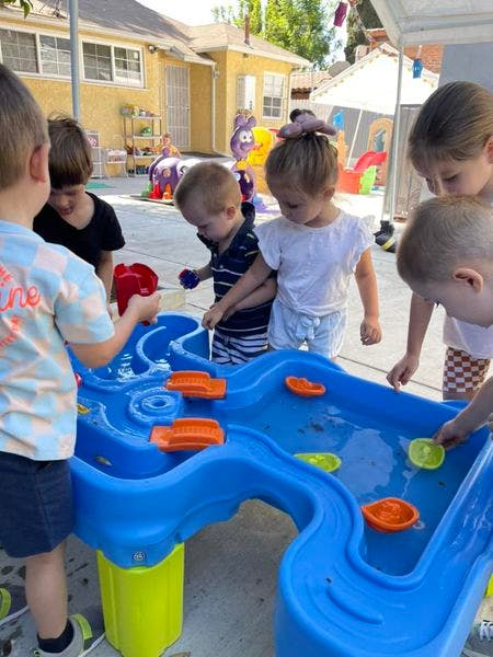 Children playing with a water table outdoors