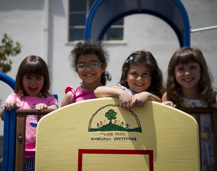 Four children on a playground structure