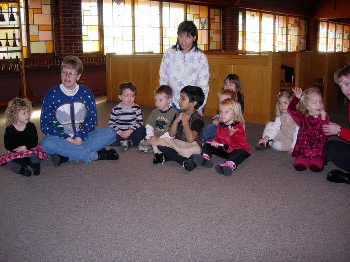 Adults and children sitting on the floor