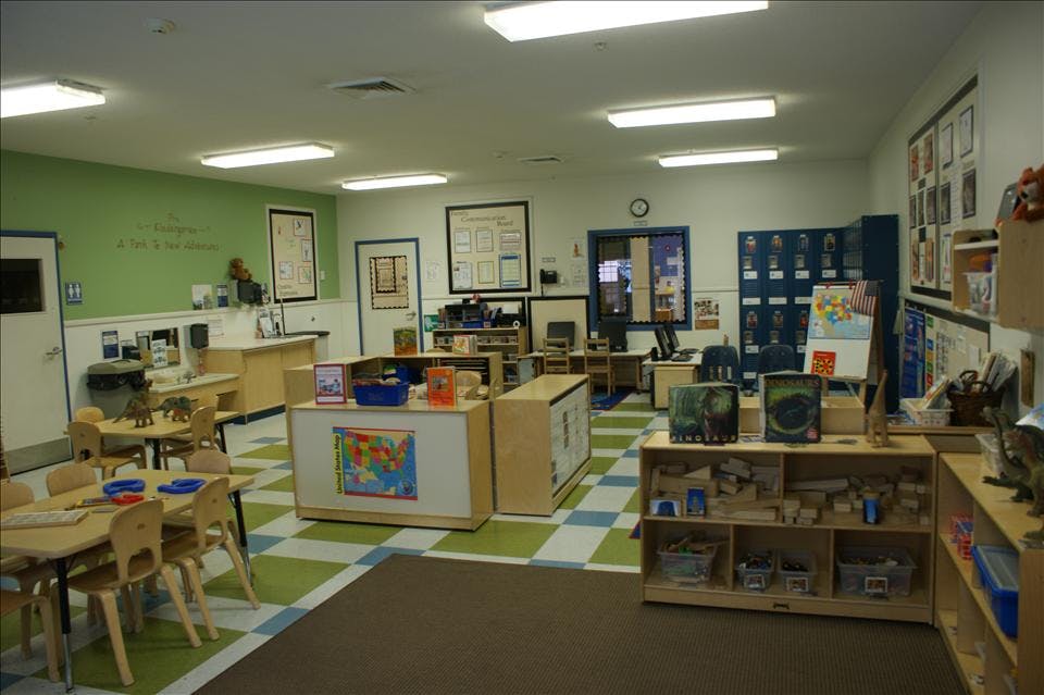 An empty early childhood education classroom with green and white checkered floors