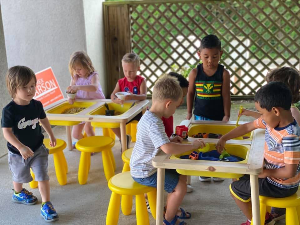 Children playing at sensory tables
