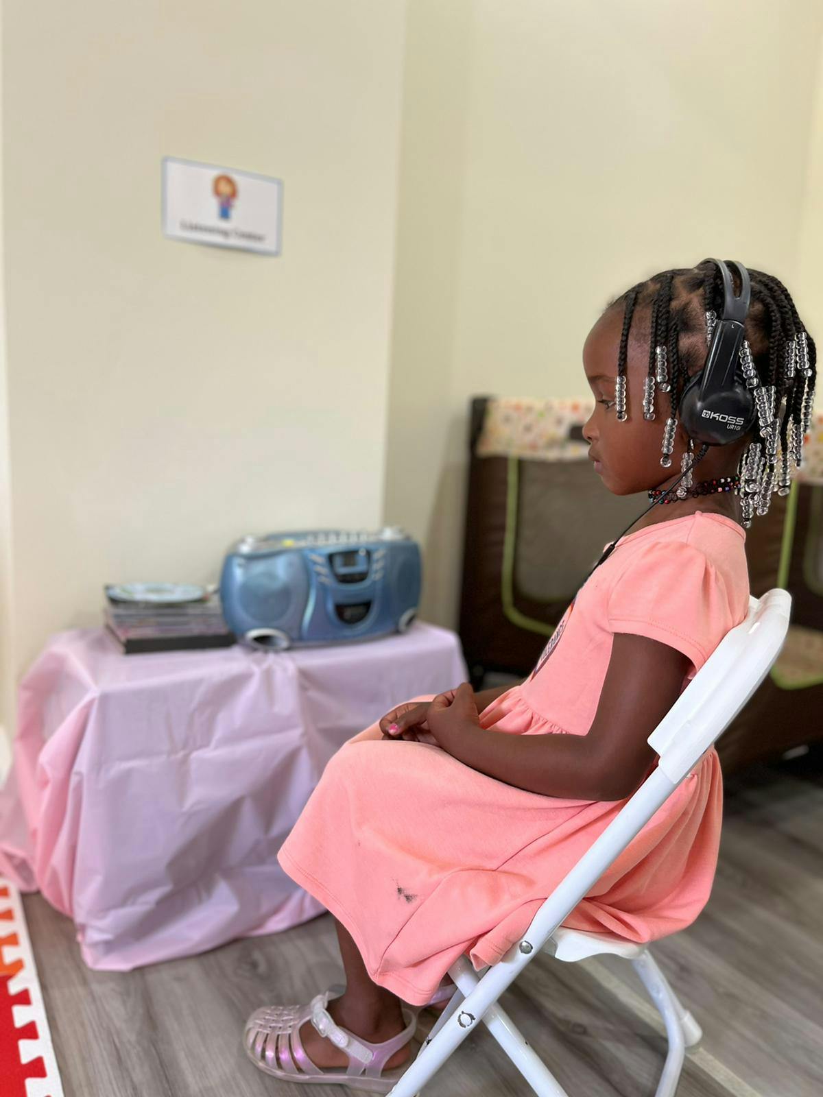 Child wearing headphones sitting in a chair
