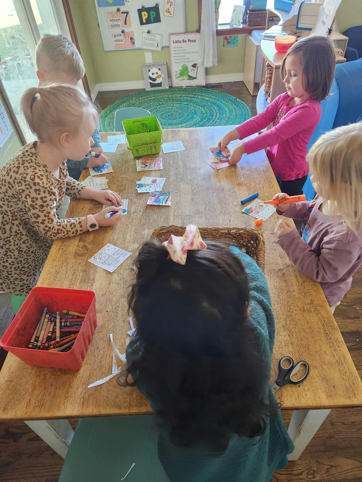 Children sitting around a table doing crafts
