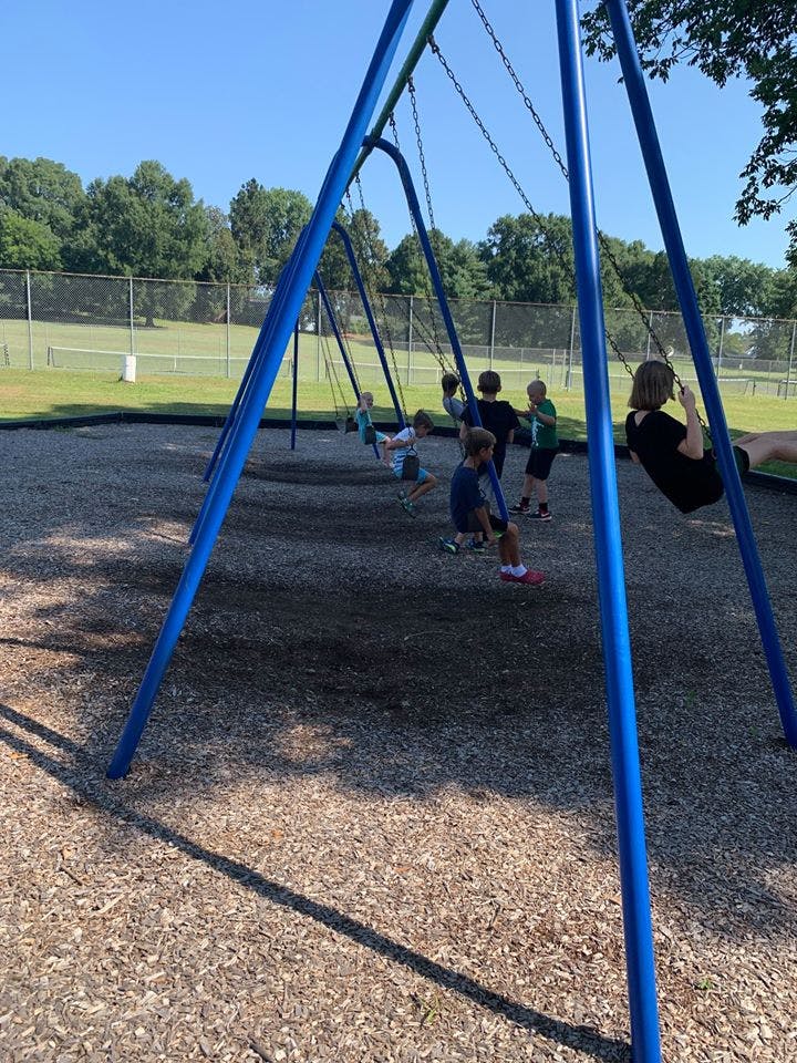 Children playing on swings at a playground