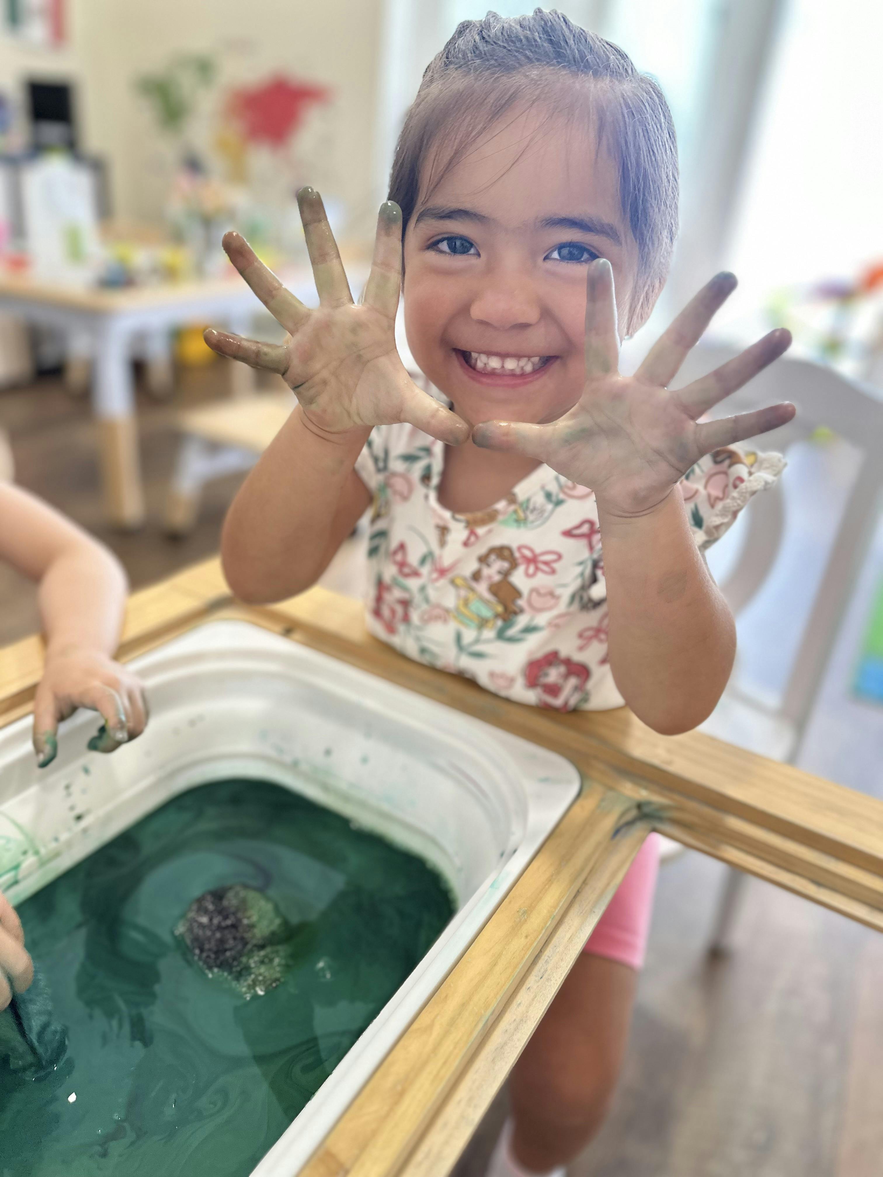 Child with dirty hands showing palms to the camera