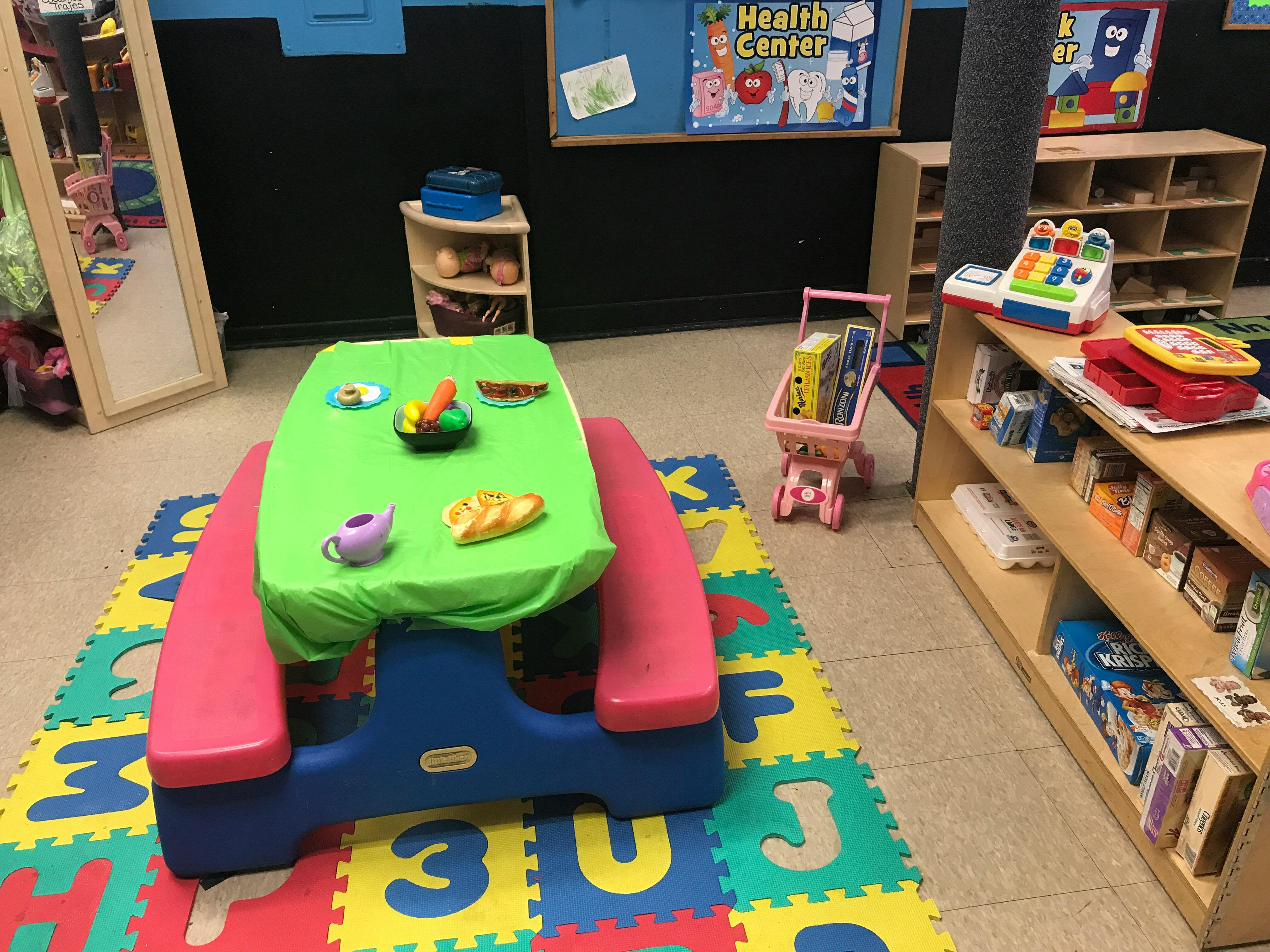 Playroom with a small table and alphabet mat
