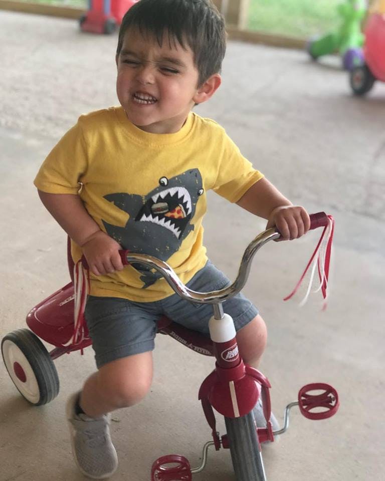 Child on a red tricycle