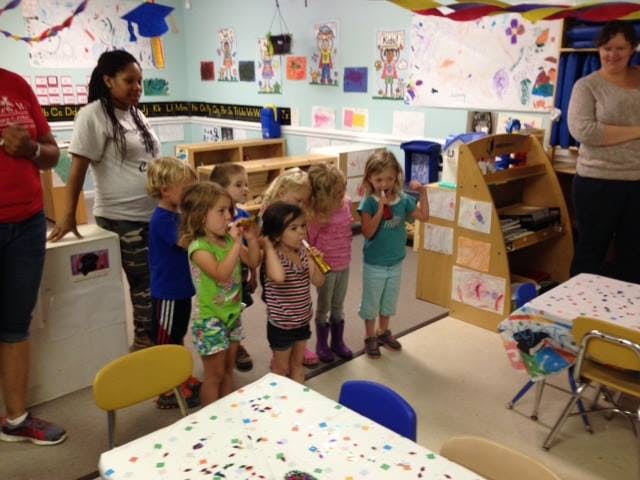Adults and children in a classroom