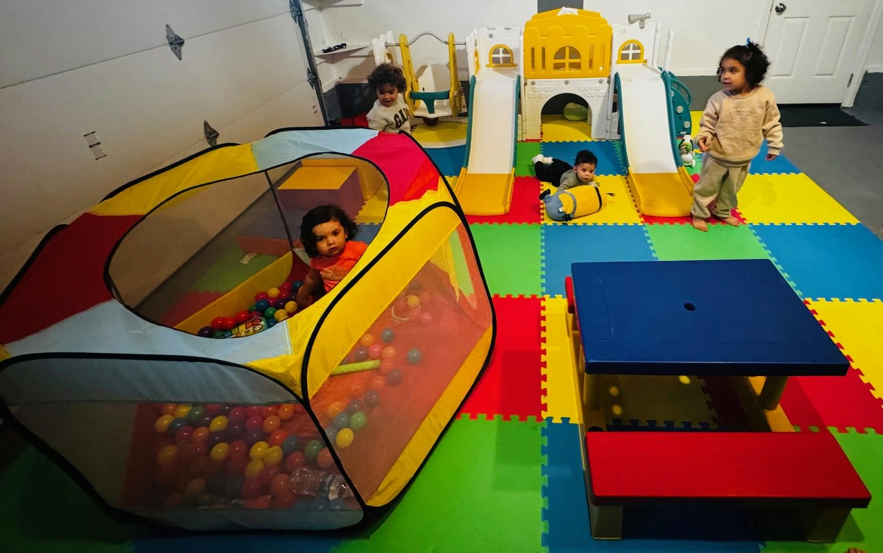 Children playing in a ball pit and on a play structure