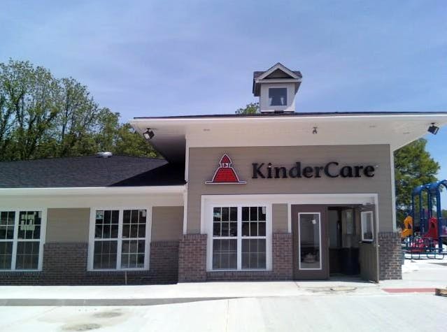 KinderCare building exterior with a playground in the background