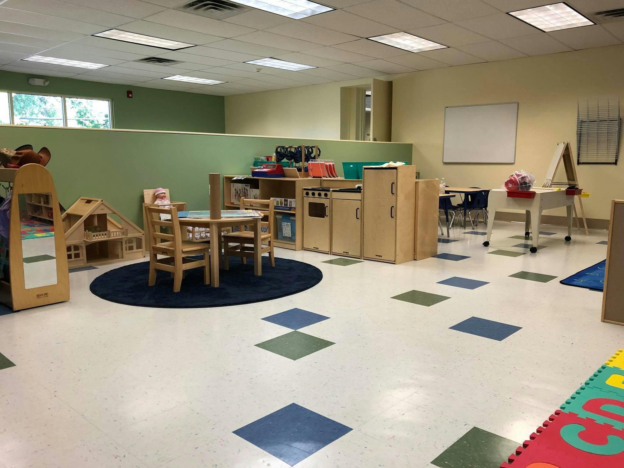Empty classroom with small tables and chairs