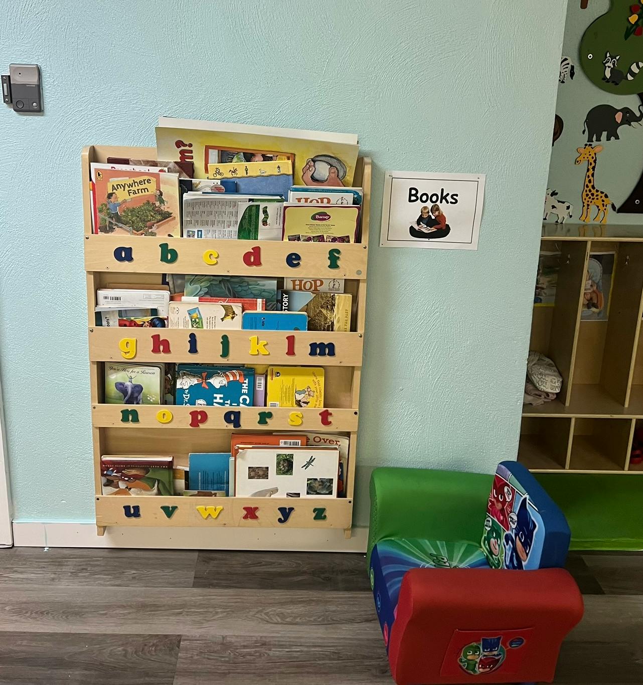 Bookshelf with children's books and a small chair
