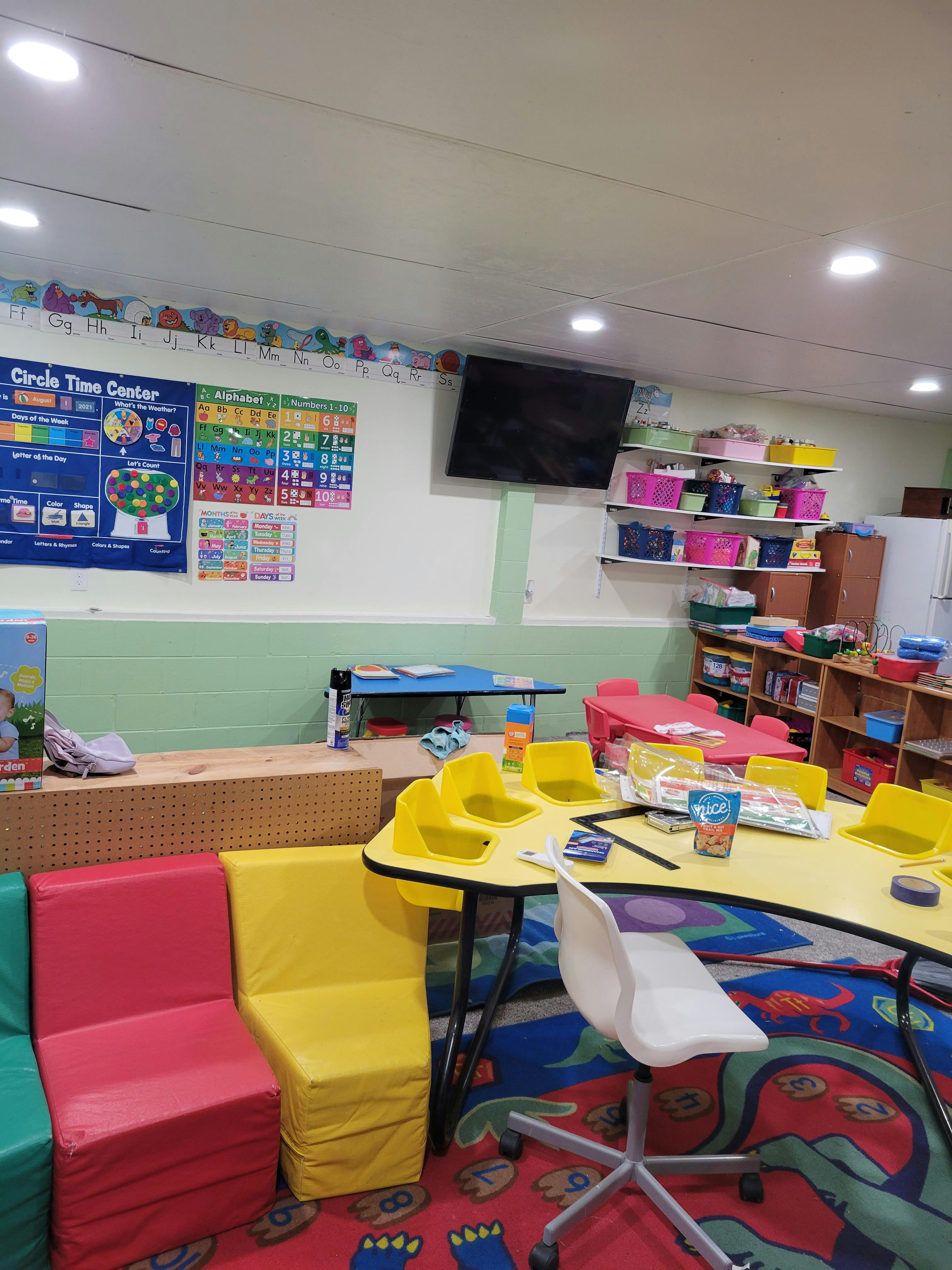 Classroom with colorful furniture, tables, and wall decorations