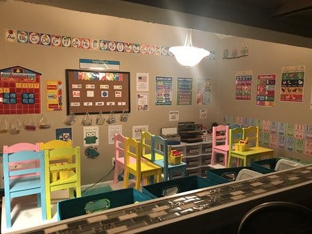 Classroom with colorful child-sized chairs and tables