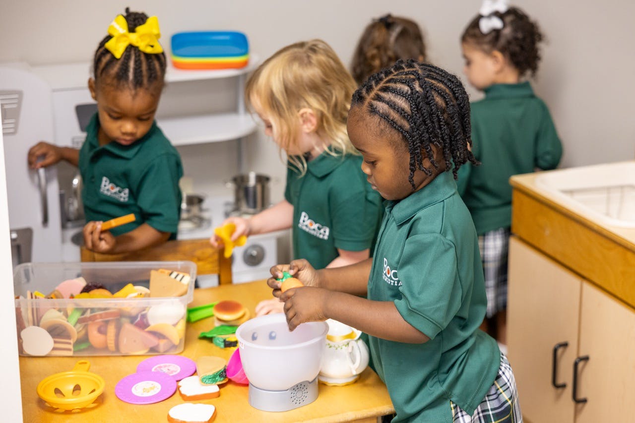 Children playing with toy kitchen and food