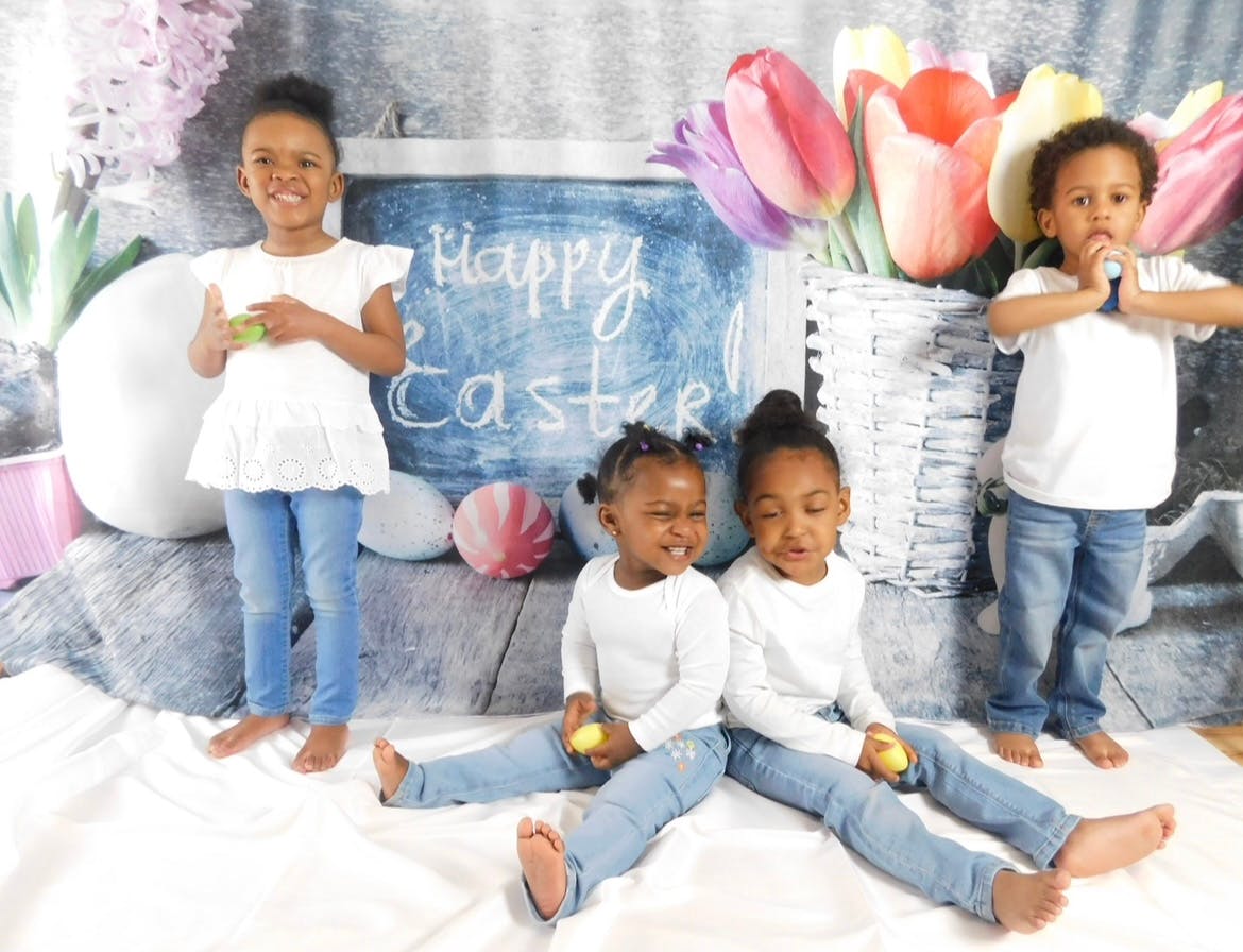 Four children posing with Easter decorations