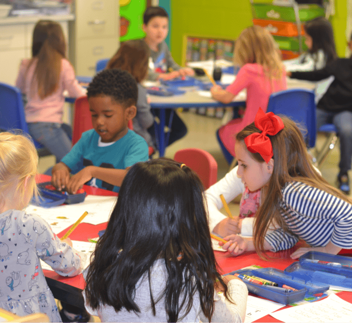 Children sitting at tables in a classroom